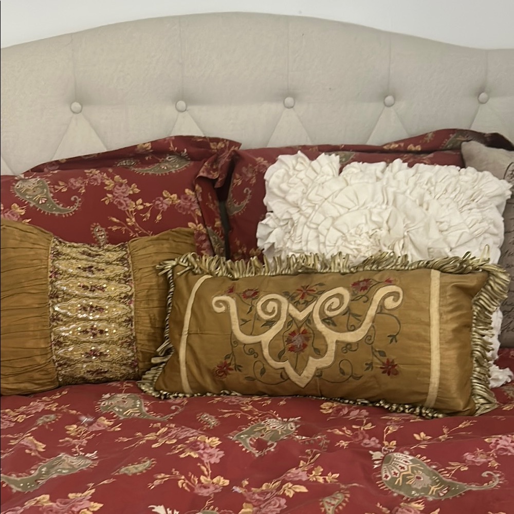 Elegant Gold and Red Accent Pillows with Tassel Details